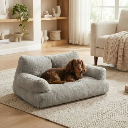 Canapé-petit-chien-douillet-anti-poils-déhoussable et lavable en machine-housse en peluche ultra-douce avec fond antidérapant et imperméable avec accoudoirs cylindrique dossier et assise au rembourrage 100% coton haute densité, ergonomique et 4 saisons, respirant et chaud-un Teckel miniature couché confortablement couché sur le canapé pour chien gris au toucher velours dans le salon de la maison