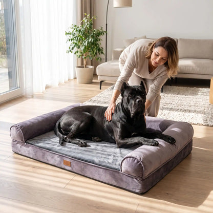 Canapé-pour-grand-chien-xxl matelas à mémoire de forme haute densité et élasticité, rebords surélevés cylindrique au rembourrage 100% Coton haute densité etourant et apaisant, coton et peluche douce, avec son tapis intérieur pour l'hiver en peluche amovible avec fermeture éclair et housse respirante, tissu oxford 100% imperméable et résistant, totalement déhoussable et lavable en machine, antidérapant-un chien de grande race couché confortablement dans son canapé lit avec rebord, caresser par sa maitresse 