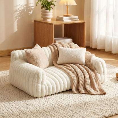 Canapé-pour-petit-chien-chiot-déhoussable-moelleux au rembourrage 100% coton haute densité, déhoussable et lavable en machine à laver, fond antidérapant et imperméable, housse en velours douce et résistante aux griffes pour chiot et chien de 0 à 7 kilos-gros plan sur le petit canapé lit pour petit chien de couleur blanc crème moelleux et douillet dans le salon de l'appartement