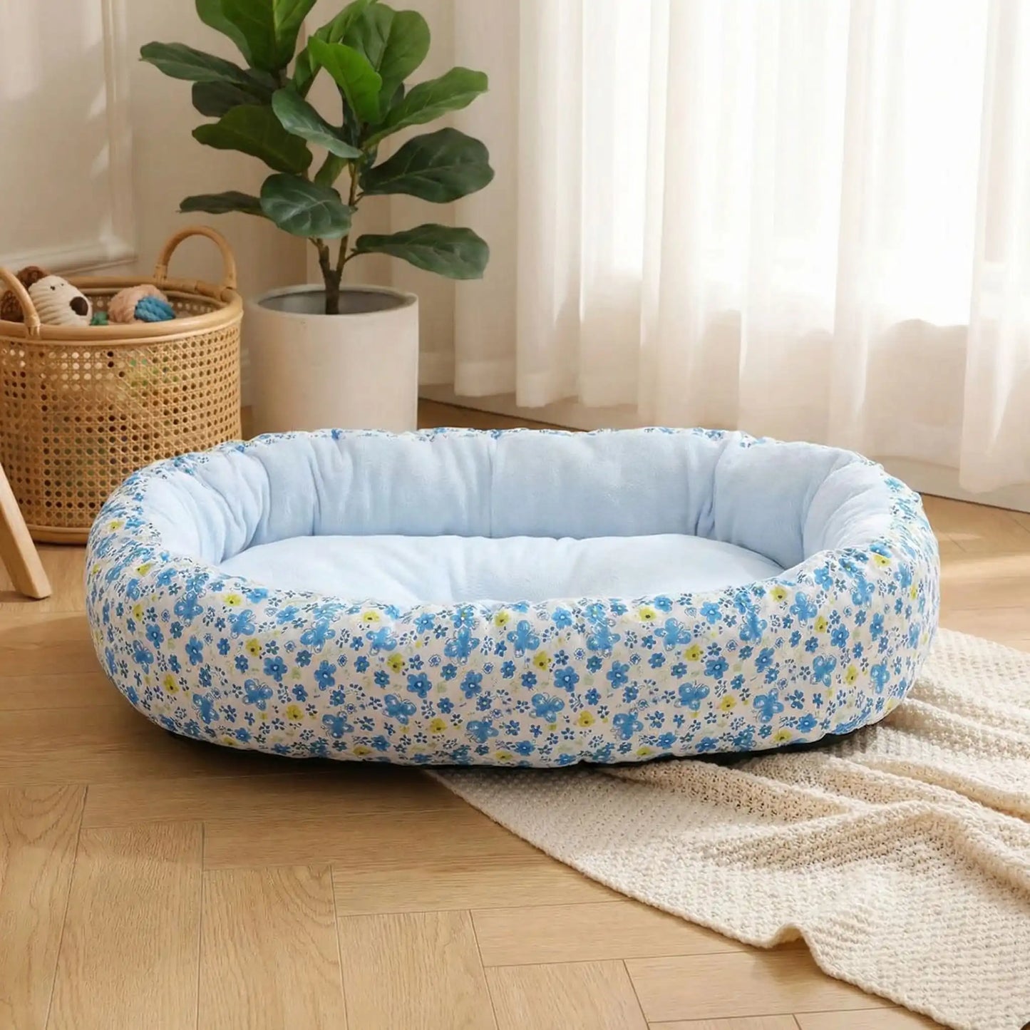 Coussin-anti-stress-chien-motif-floral-apaisant de forme ovale avec rebord surélevé à 360° pour un effet anti anxiété- ergonomique rembourrage et tissu 100% coton haute densité écologique et hypoallergénique-design pastel avec fleur délicates-lavable en machine et antidérapant pour chien de petite taille de 0 à 12 kilos-design frais de floral sur le tissu exterieur, couleur unie à l'intérieur de couelur bleu pastel en 2 tailles S et M