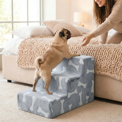 Escalier-mousse-pour-chien et chiot antidérapant, déhoussable lavable en machine avec mousse haute résilience à mémoire de forme pour protèger les articulations sensibles, sécurisé , confortable, résistant aux griffes pour petit et chien de moyenne taille-design peluche sur le dessus ultra-douce et tissu en coton solide-un carlin qui monte sur l'escalier de 3 hautes marches en mousse pour rejoindre en toute sécurité le lit ou sa maitresse 'attend en allongé et tendant le bras vers lui pour l'encourager