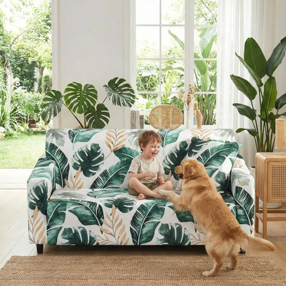 Protection-canape-chien-anti-poils-anti accident, lavable en machine, haute élasticité et resistante aux griffes et à l'usure, universelle en 4 tailles pour fauteuil, canapé de 2/3/4 places, avec élastique et bloque plis-un enfant qui joue avec un grand chien sur le canapé avec sa housse universelle adaptable à tous les canapés au design de nature soignée dans la véranda ouverte de la maison