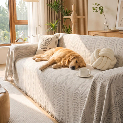 Protection-canape-chien-anti-poils-résistante aux griffes, tissage chenille coton et polyester, écoresponsable avec franges pour un style bohème chic de couleur gris clair, dispoinble en 4 tailles pour fauteuil/canapé une place, deux places, 3 places et 4 places, lavable en machine, doux respirant confortable et 4 saisons-un chien de grande taille qui dort paisiblement sur le flanc sur le protège canapé 3 places dans le salon de la maison
