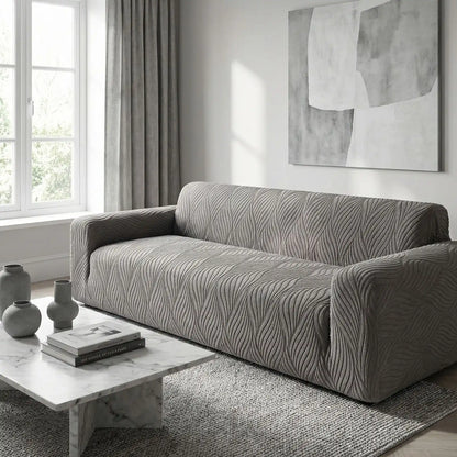 Protection-canape-antiderapant-4-saisons, extensible, lavabkle en machine avec relief doux et sécurisant , tissu anti poils et résistant aux griffes, idéal pour les propriétaire de chiens, 4 tailles disponible du fauteuil 1 places au XL pour canapé 4 places-gros plan sur la protection de canapé gris qui protège le canapé 4 places de la salle d'attente du cabinet