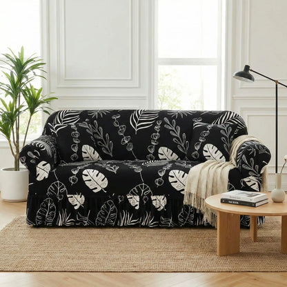 Protection-canape-chien-anti-poils-anti accident, lavable en machine, haute élasticité et resistante aux griffes et à l'usure, universelle en 4 tailles pour fauteuil, canapé de 2/3/4 places, avec élastique et bloque plis- design floral délicat- photo du canapé avec sa housse extensible universelle noir er design feuille déco dans le salon de l'appartement